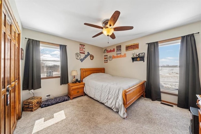 bedroom with visible vents, carpet, and ceiling fan