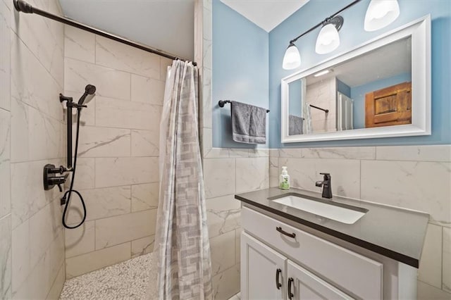 full bathroom featuring vanity, tile walls, and a tile shower