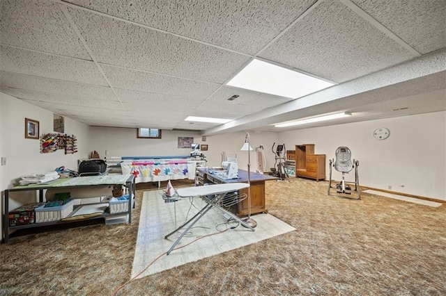 carpeted office space with visible vents, baseboards, and a drop ceiling