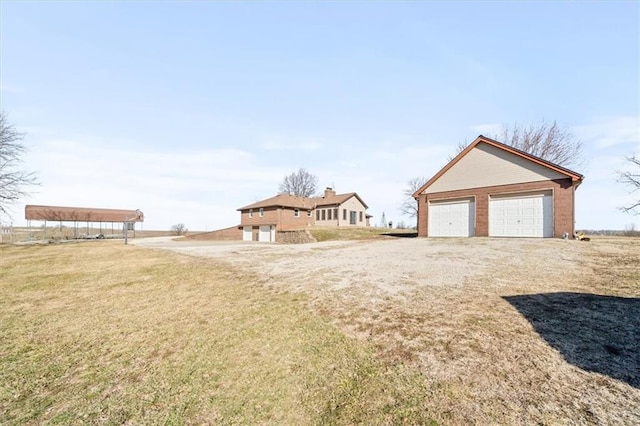 view of front of home with an outbuilding, a front lawn, and a garage