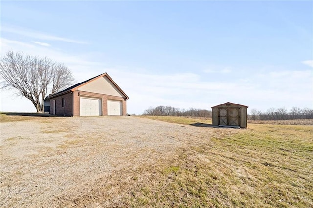 exterior space featuring a storage shed, an outbuilding, and a garage