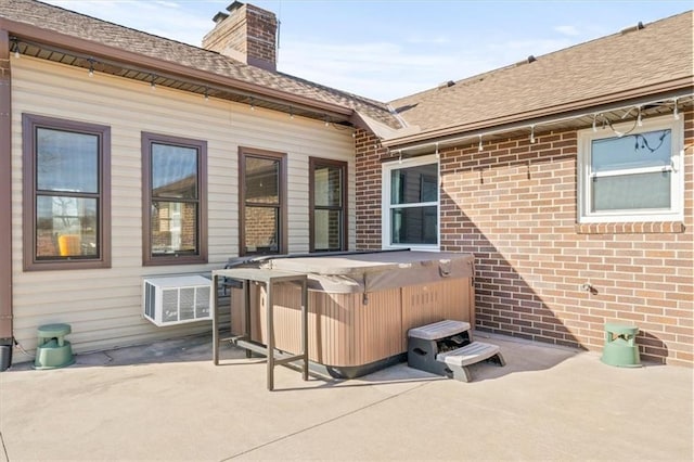 view of patio with visible vents and a hot tub