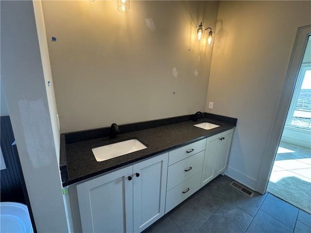 full bathroom with tile patterned floors, visible vents, double vanity, and a sink