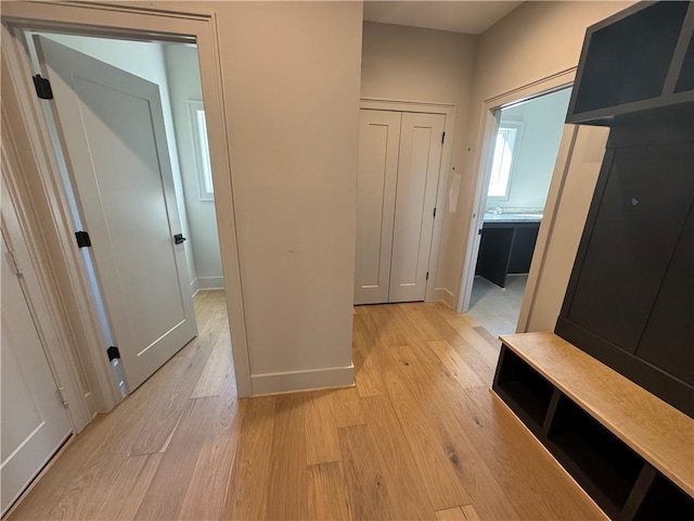 mudroom featuring light wood-type flooring and baseboards