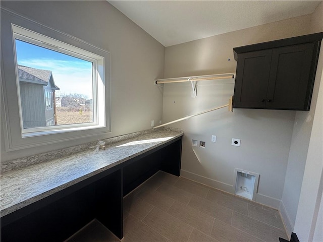 clothes washing area with baseboards, cabinet space, hookup for an electric dryer, and hookup for a washing machine