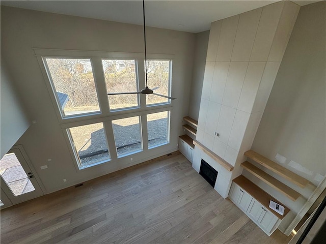 unfurnished living room featuring visible vents and light wood-style flooring