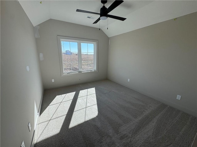 carpeted empty room with lofted ceiling, visible vents, and ceiling fan