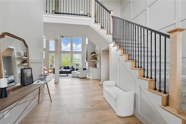 1506 NW 106th Ter, Kansas City, MO 64155 - entrance foyer with stairs, a high ceiling, and wood finished floors