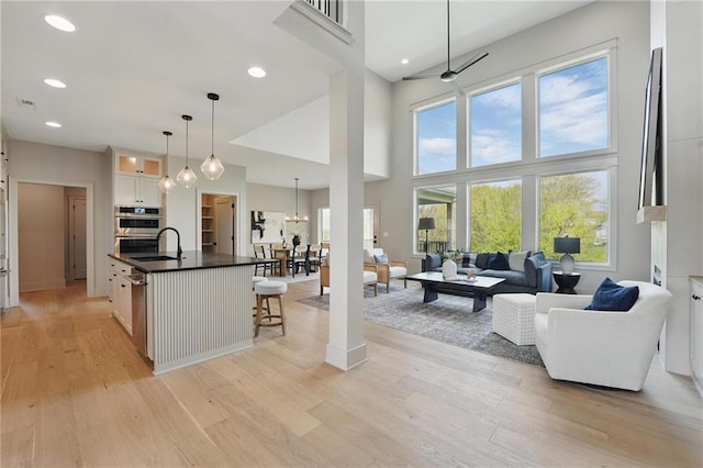 1506 NW 106th Ter, Kansas City, MO 64155 - living area featuring light wood-style floors, recessed lighting, and a high ceiling