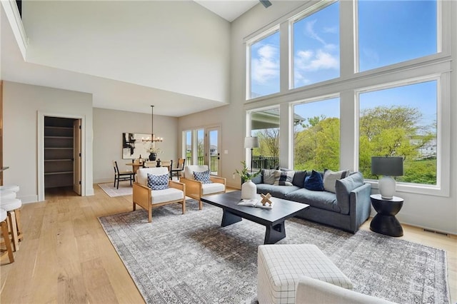 1506 NW 106th Ter, Kansas City, MO 64155 - living area featuring a high ceiling, a notable chandelier, visible vents, and light wood-style floors
