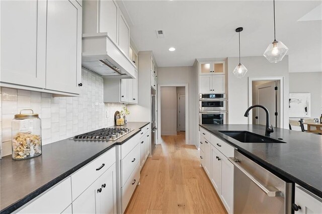 1506 NW 106th Ter, Kansas City, MO 64155 - kitchen featuring white cabinetry, dark countertops, appliances with stainless steel finishes, and a sink