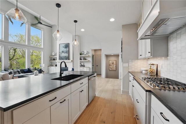 1506 NW 106th Ter, Kansas City, MO 64155 - kitchen with dark countertops, a sink, stainless steel appliances, open floor plan, and under cabinet range hood