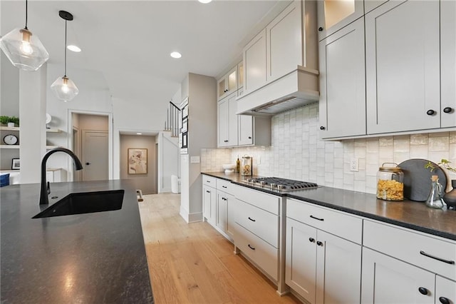 1506 NW 106th Ter, Kansas City, MO 64155 - kitchen with a sink, dark countertops, tasteful backsplash, and stainless steel gas stovetop