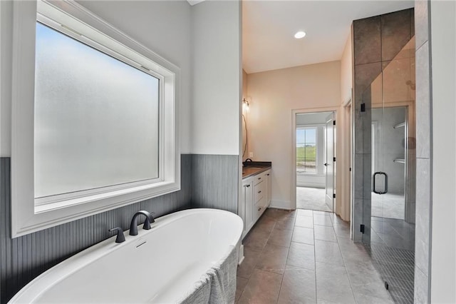 1506 NW 106th Ter, Kansas City, MO 64155 - bathroom featuring a freestanding tub, a shower stall, vanity, and tile patterned floors