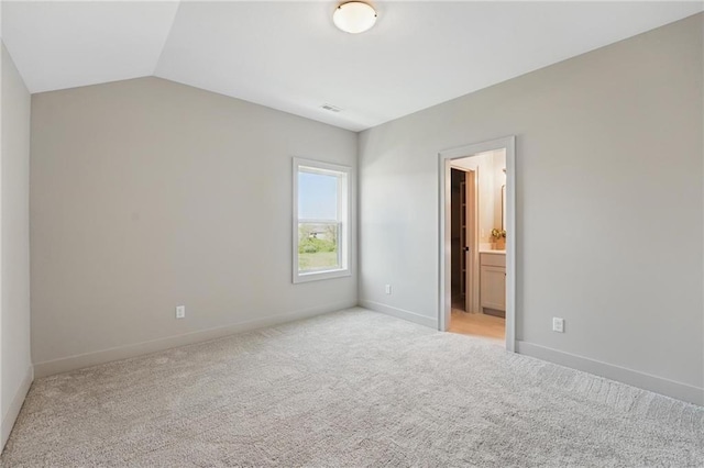 1506 NW 106th Ter, Kansas City, MO 64155 - unfurnished bedroom with connected bathroom, carpet, baseboards, lofted ceiling, and visible vents
