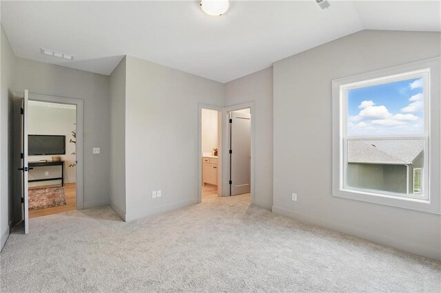 1506 NW 106th Ter, Kansas City, MO 64155 - unfurnished bedroom with baseboards, visible vents, light carpet, and lofted ceiling