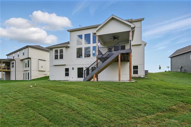 1506 NW 106th Ter, Kansas City, MO 64155 - back of property featuring a yard, a ceiling fan, and stairs