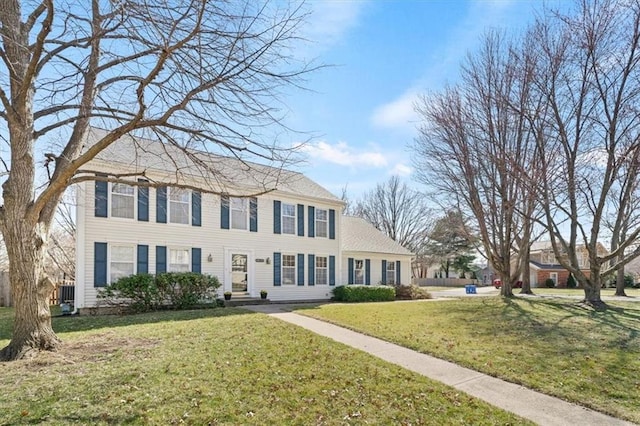 colonial-style house with a front lawn