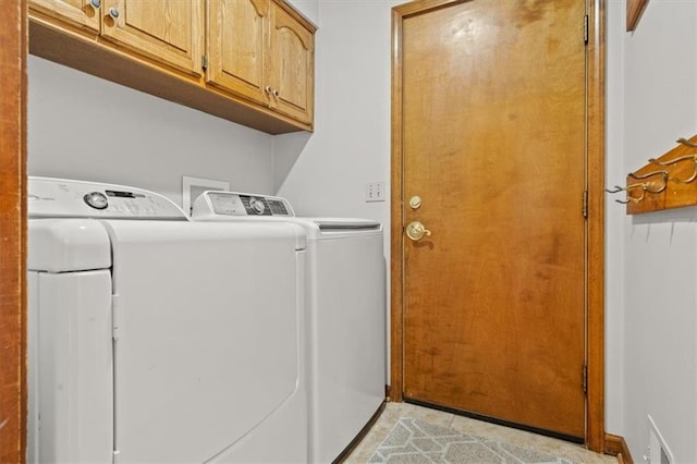 laundry area with washer and dryer, visible vents, cabinet space, and light tile patterned floors