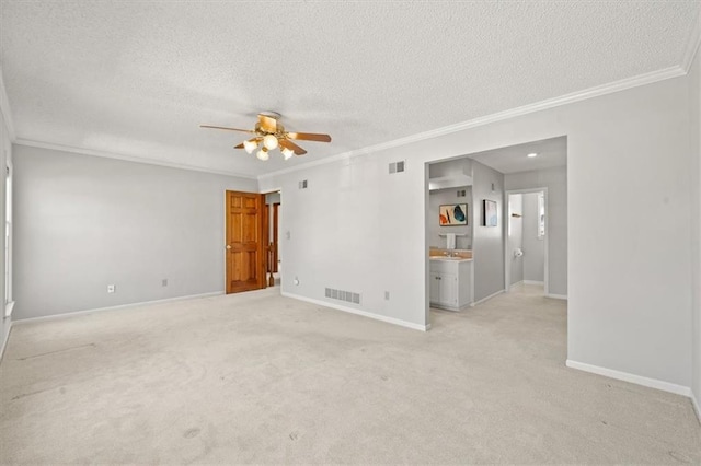 empty room with visible vents, a textured ceiling, and baseboards