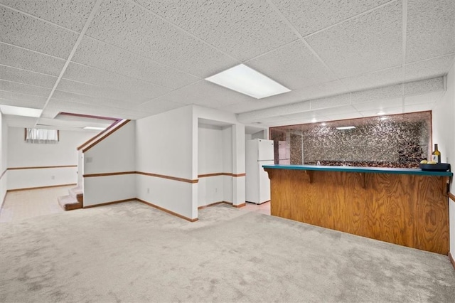 bar with baseboards, stairway, a dry bar, carpet floors, and freestanding refrigerator