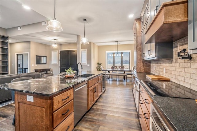 kitchen with a sink, black electric cooktop, brown cabinets, and stainless steel dishwasher