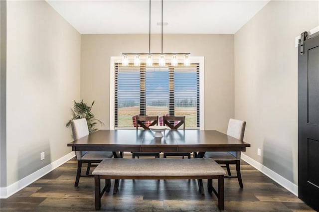 dining room with a barn door, visible vents, baseboards, and dark wood-style flooring