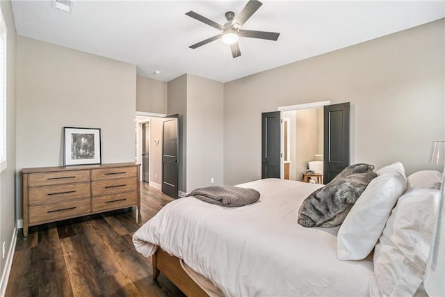 bedroom with dark wood-type flooring, visible vents, ceiling fan, and baseboards