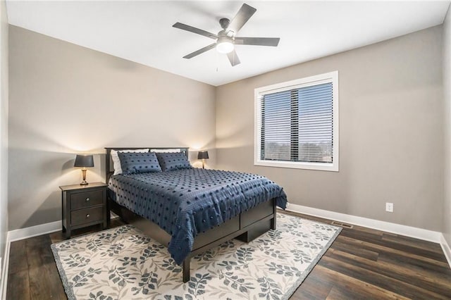 bedroom featuring wood finished floors, a ceiling fan, and baseboards