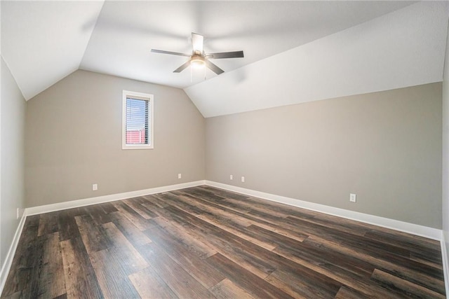 bonus room with dark wood-style floors, lofted ceiling, baseboards, and a ceiling fan