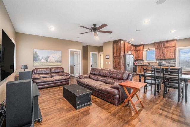 living area with ceiling fan, wood finished floors, and recessed lighting