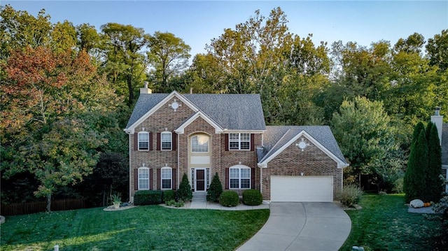 colonial-style house with brick siding, concrete driveway, a front yard, a chimney, and a garage