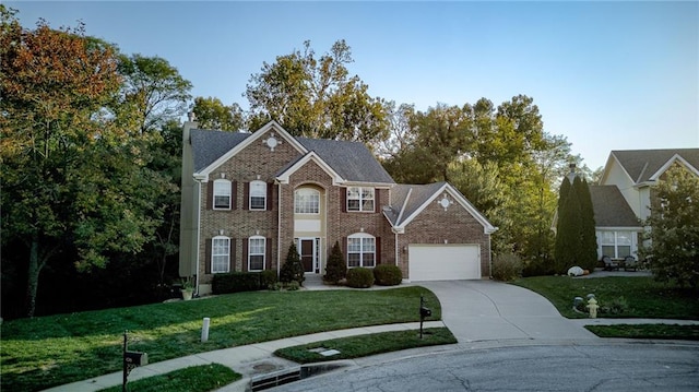 colonial house with driveway, a front yard, a garage, brick siding, and a chimney