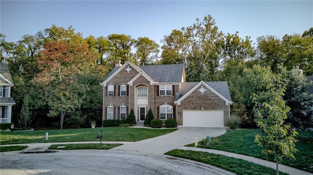 view of front of house featuring a front lawn, concrete driveway, brick siding, and a garage