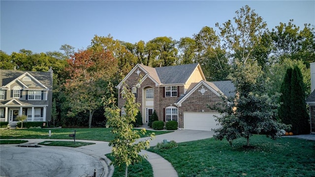 view of front facade with driveway, brick siding, an attached garage, and a front lawn