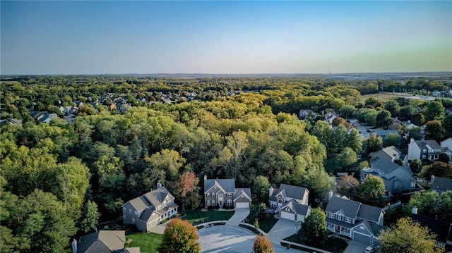 drone / aerial view featuring a view of trees and a residential view