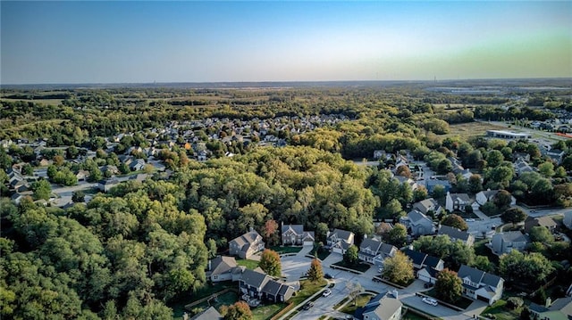 birds eye view of property featuring a residential view and a wooded view