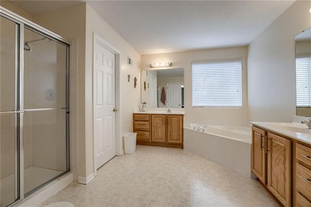 bathroom with a sink, two vanities, a bath, and a shower stall