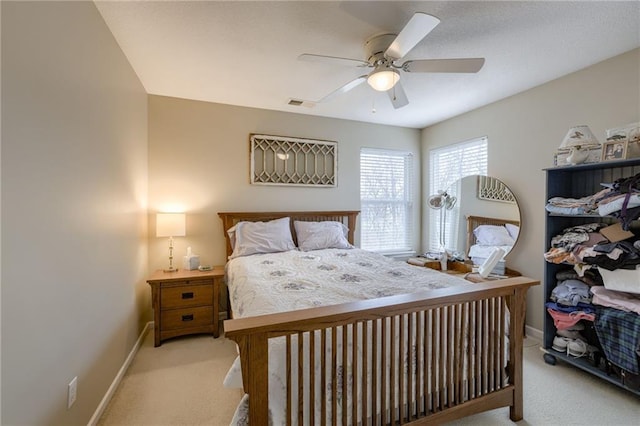 bedroom with visible vents, baseboards, a ceiling fan, and carpet flooring