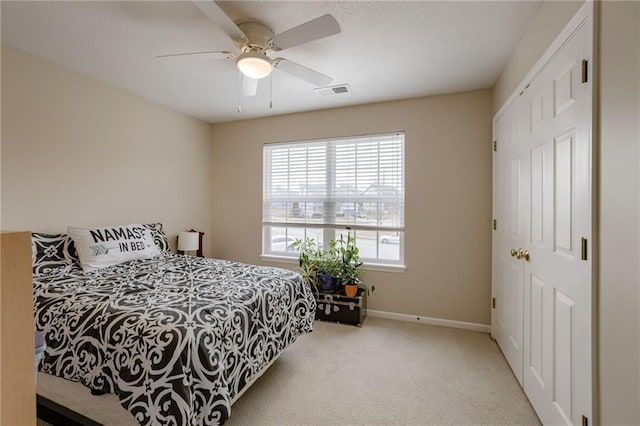 bedroom featuring visible vents, baseboards, carpet, and ceiling fan