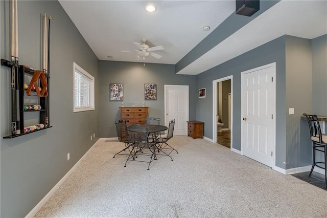 interior space with baseboards, ceiling fan, and carpet floors