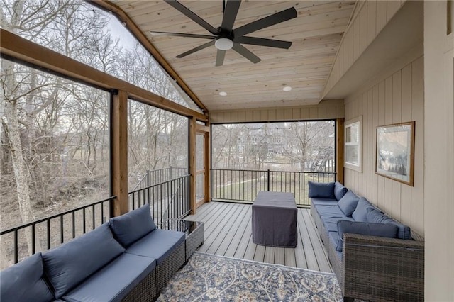 sunroom / solarium with plenty of natural light, wood ceiling, ceiling fan, and vaulted ceiling