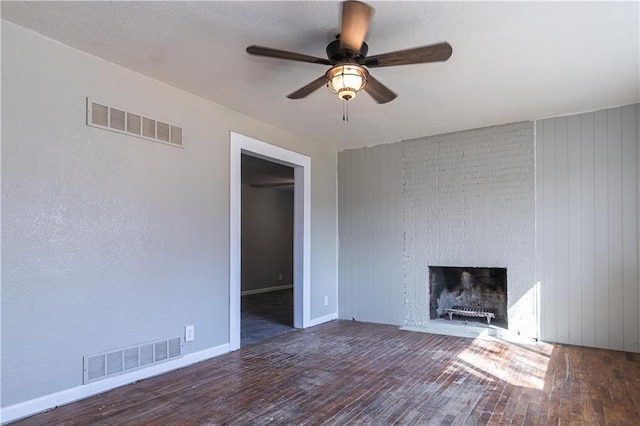 unfurnished living room with visible vents, ceiling fan, and hardwood / wood-style flooring