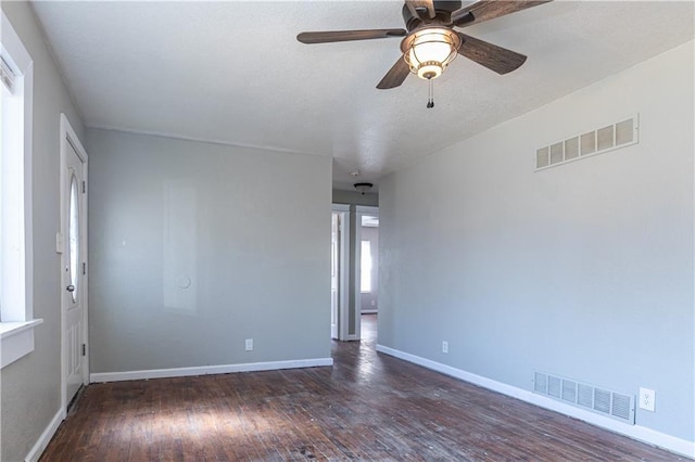 unfurnished room with hardwood / wood-style flooring, baseboards, and visible vents