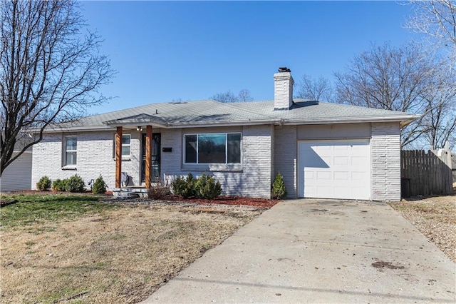 ranch-style home featuring driveway, fence, an attached garage, brick siding, and a chimney