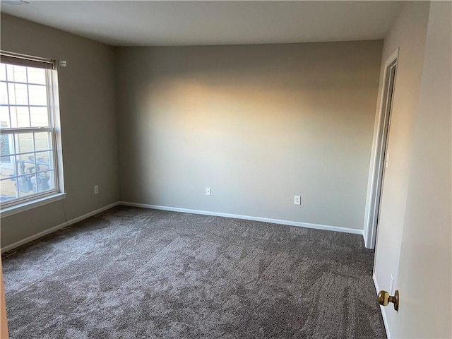 carpeted empty room with baseboards