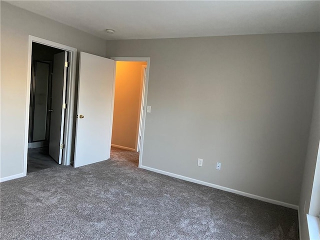 unfurnished bedroom with carpet and baseboards