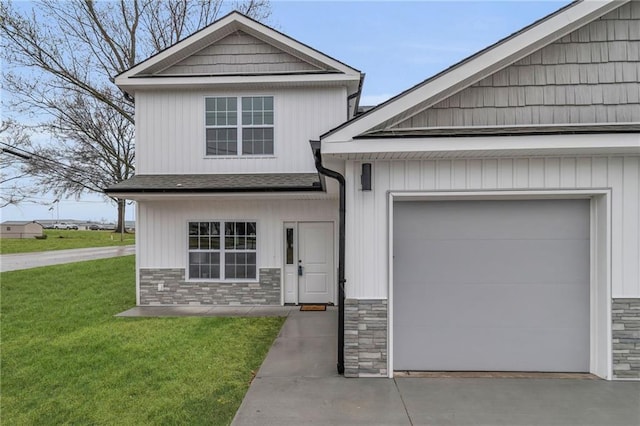 craftsman-style house with driveway, stone siding, a garage, and a front yard