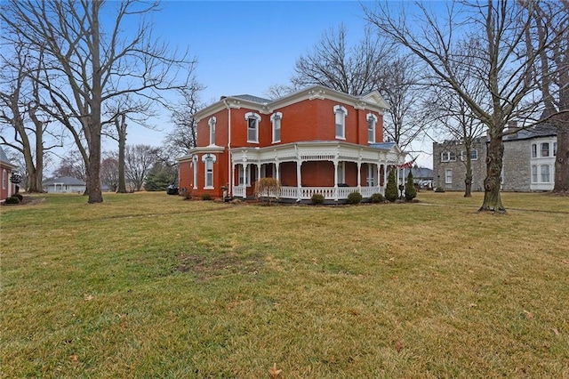 exterior space featuring covered porch, a front yard, and brick siding