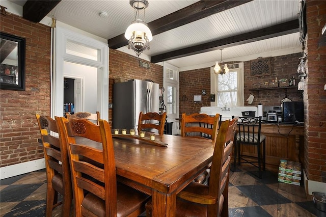 dining room with baseboards, brick wall, beam ceiling, and an inviting chandelier